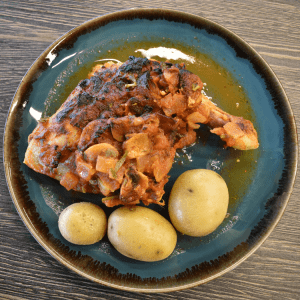 chicken with new potatoes on blue plate
