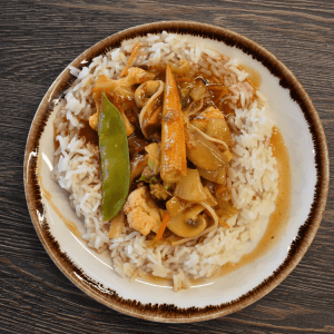 vegetables in an orange sauce on white rice